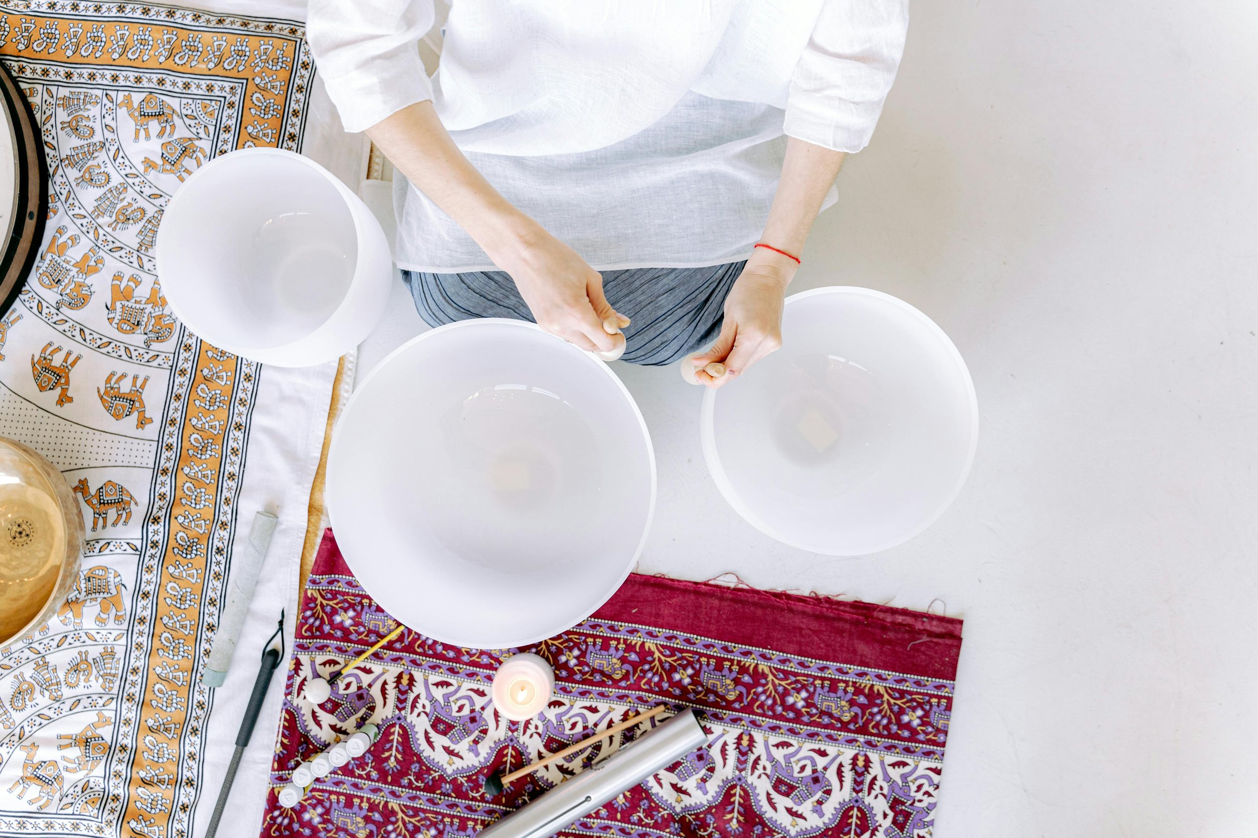 Facilitator leading a workplace sound bath with a gong for a corporate team - Chakra Hours