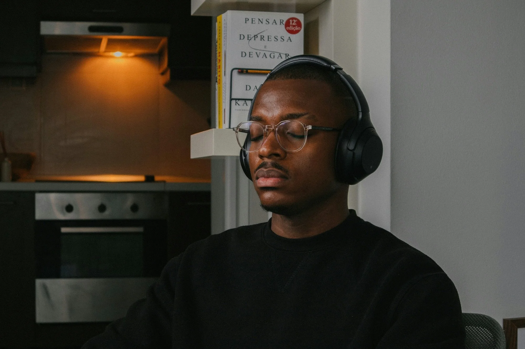 Man meditating with over-ear headphones, eyes closed, during a guided mindfulness break - guide to the 7 chakras - Chakra Hours