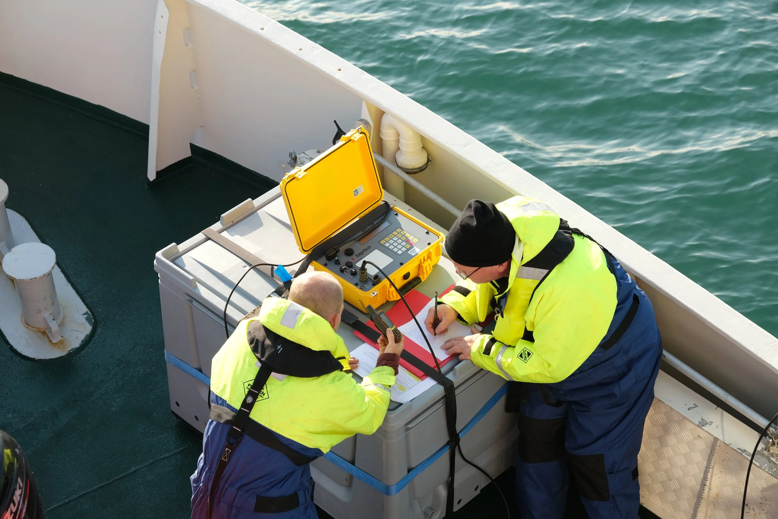 Researchers connecting a module onboard MV Ulla Rinman.