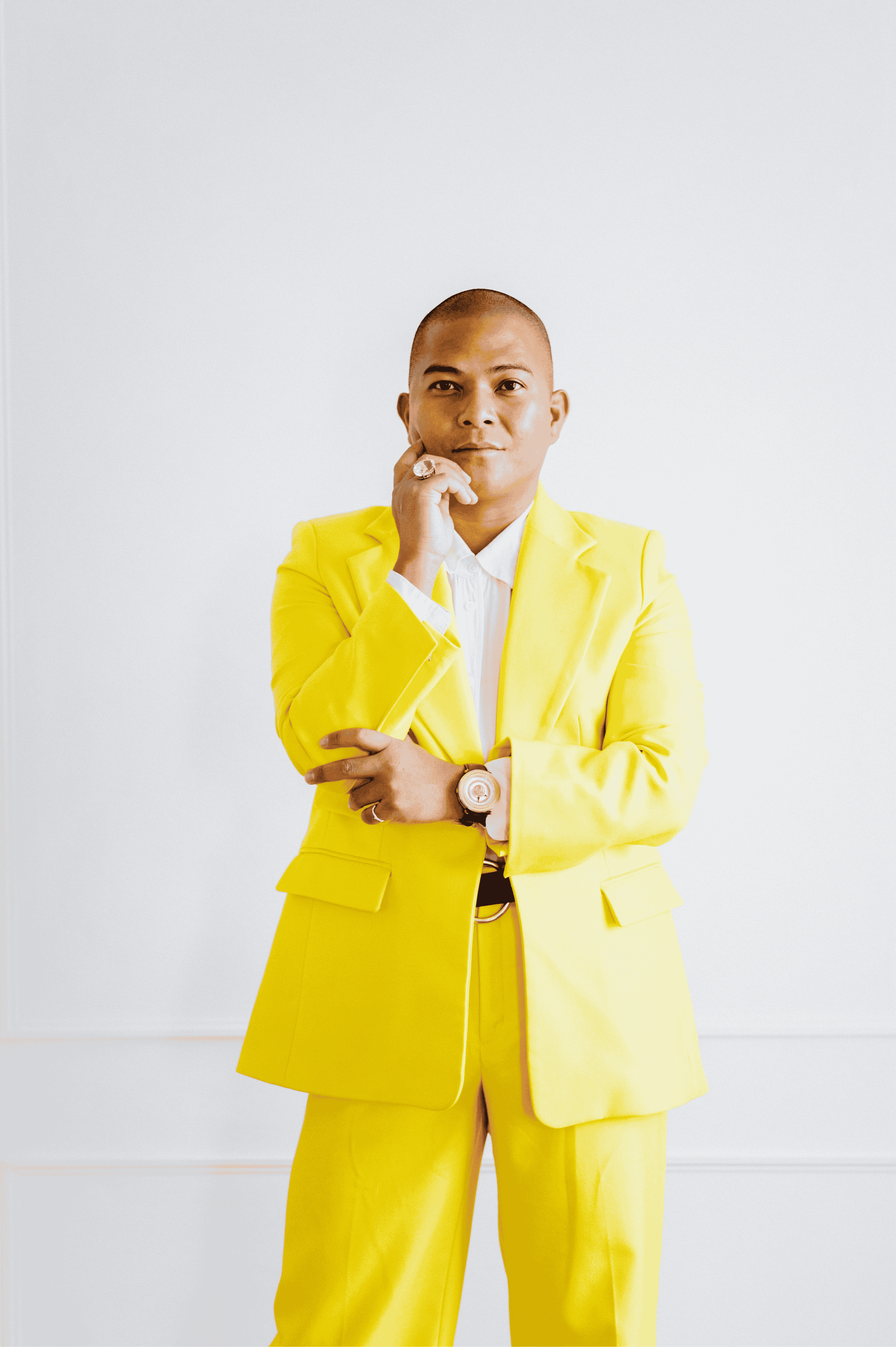 Domingo Lumanog Profile Image - gay man standing tall in yellow suit professional and smart
