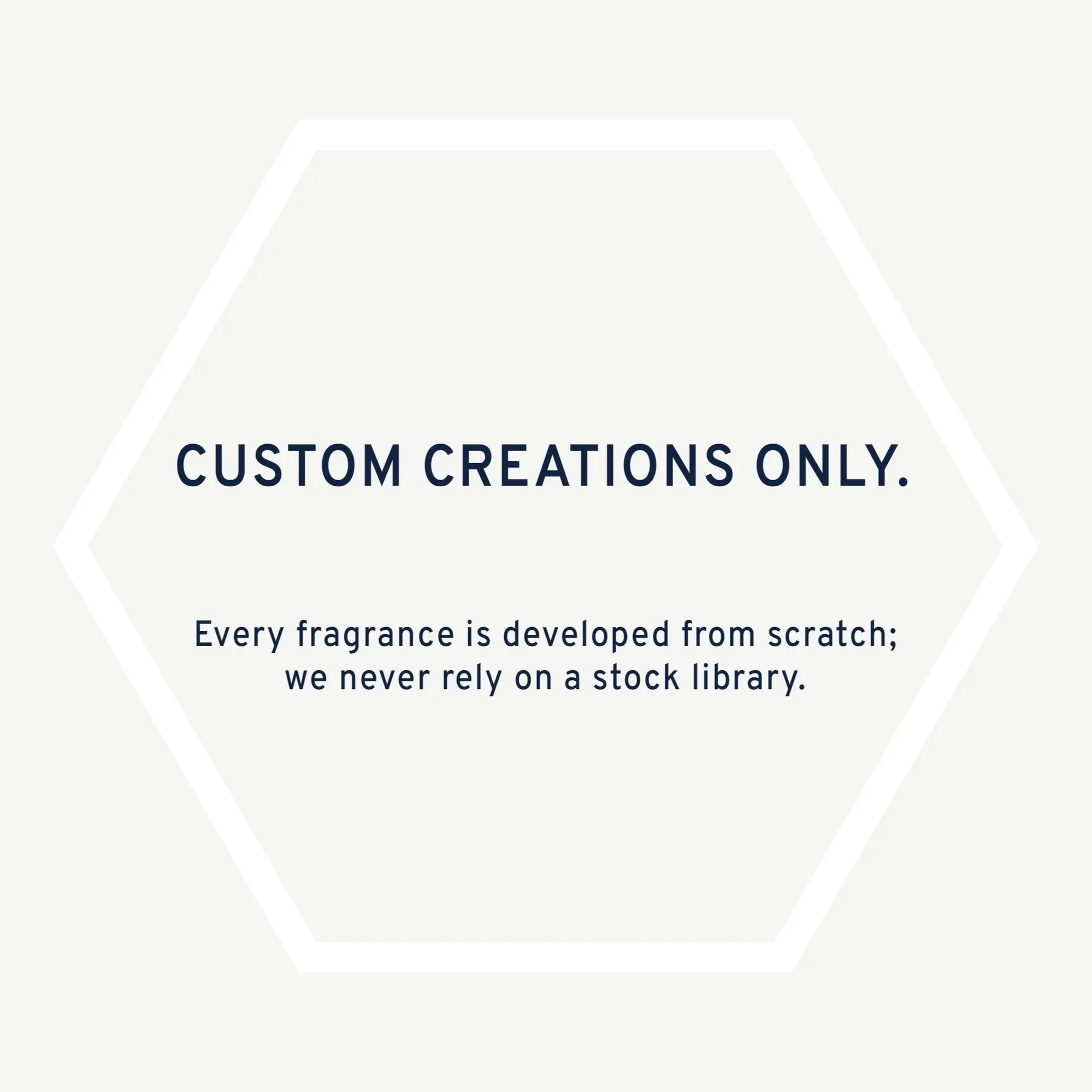 Text on a white hexagon background reads: 'CUSTOM CREATIONS ONLY. Every fragrance is developed from scratch; we never rely on a stock library.'