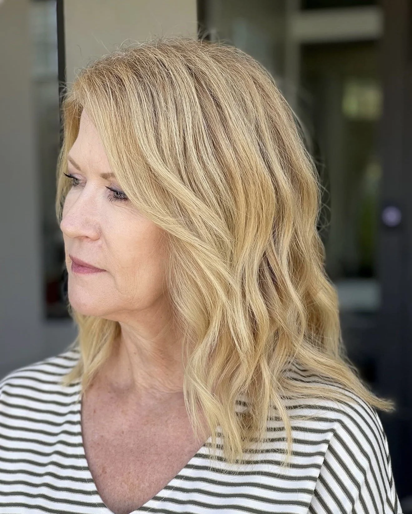 Soft dimensional blonde color with loose waves and lived-in brightness. 