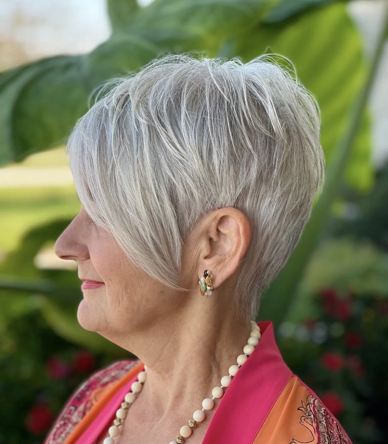 Short precision haircut designed to enhance natural silver hair. 