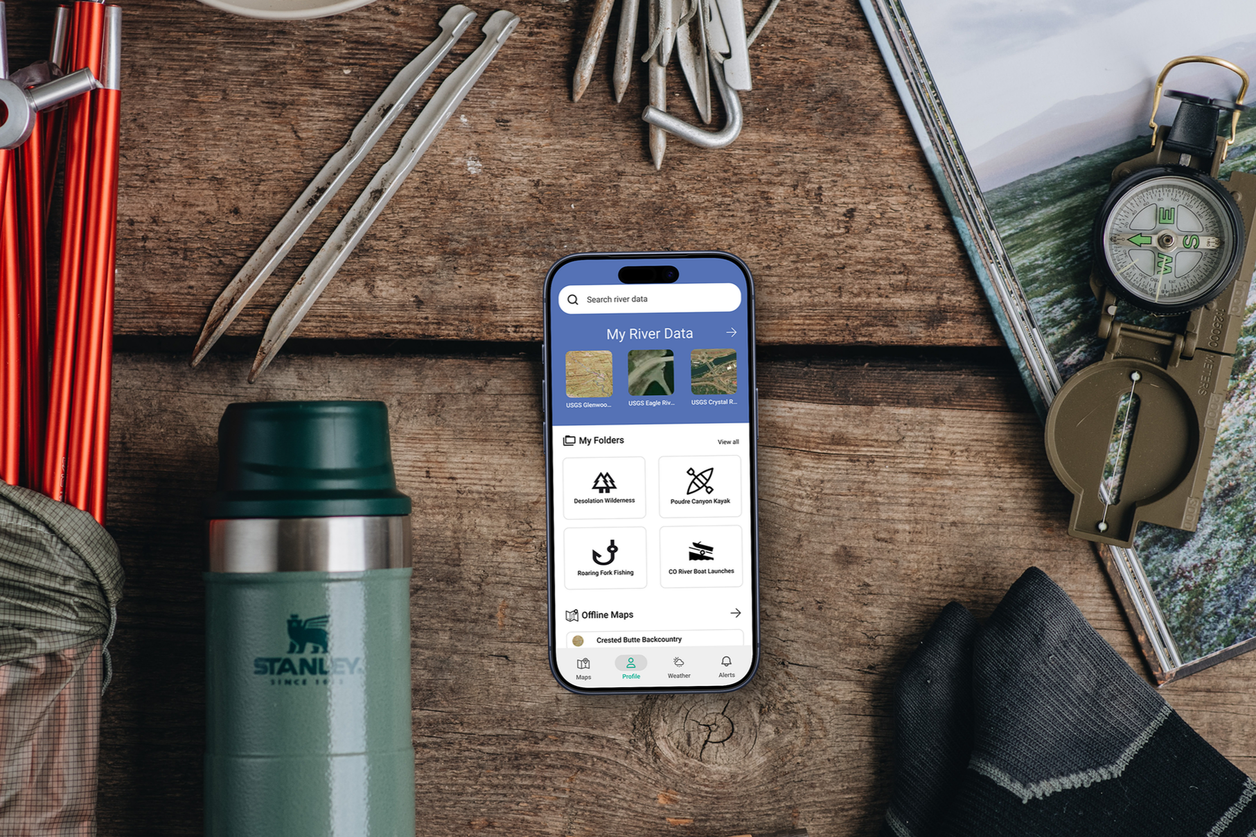 Smartphone+mockup+with+camping+supplies+%28Mockuuups+Studio%29.png