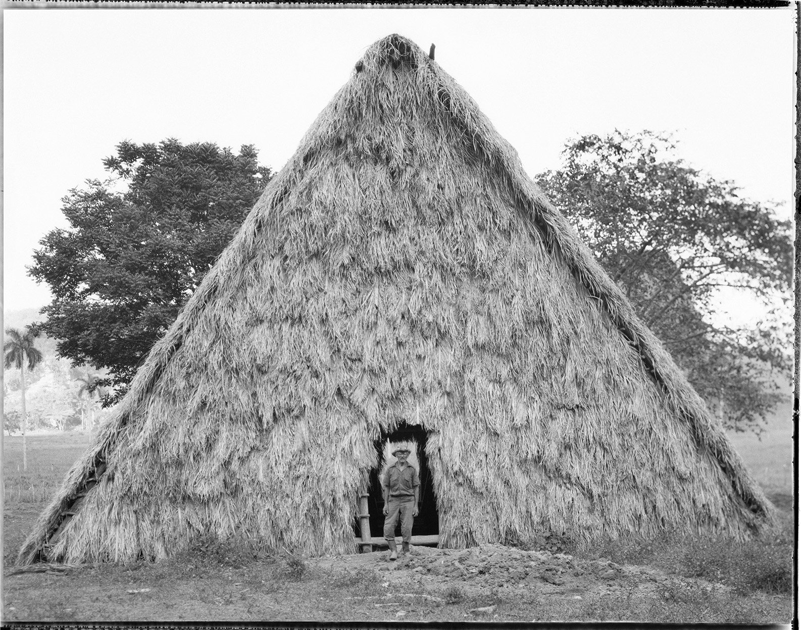 Farmer in front of Casa Tabac, used for curing tobacco leaves.