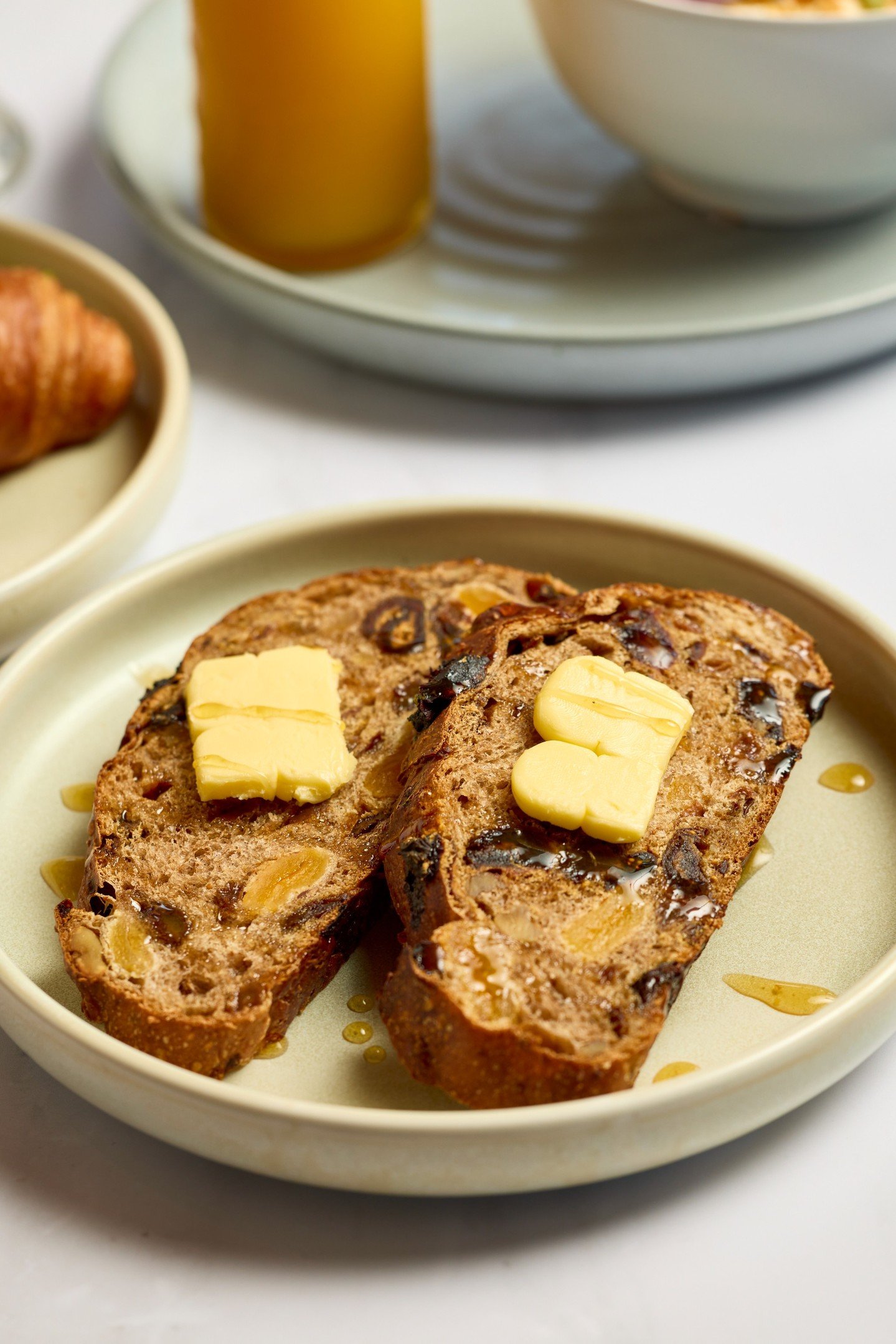 Our fruit toast is the ultimate comfort snack. Warm, buttery, and drizzled with locally sourced honey.