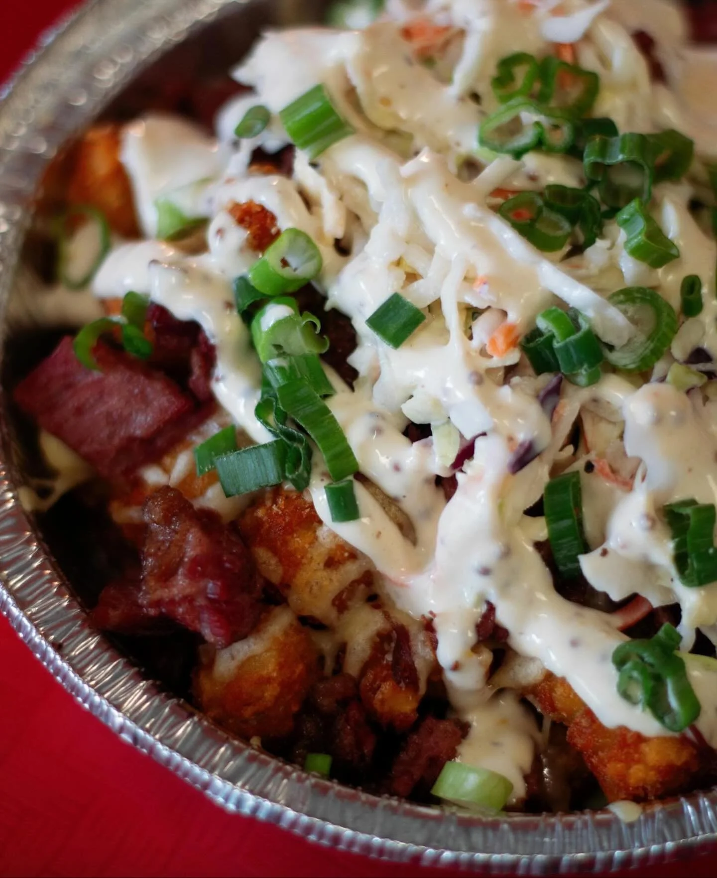 We took a crunchy mountain of tater tots and did something irresponsible with it. 🍀

Guinness-braised chopped corned beef. Melted Dubliner Irish cheddar. Crisp cabbage slaw. Pickled jalape&ntilde;os. Green onions. Guinness whole-grain mustard aioli.