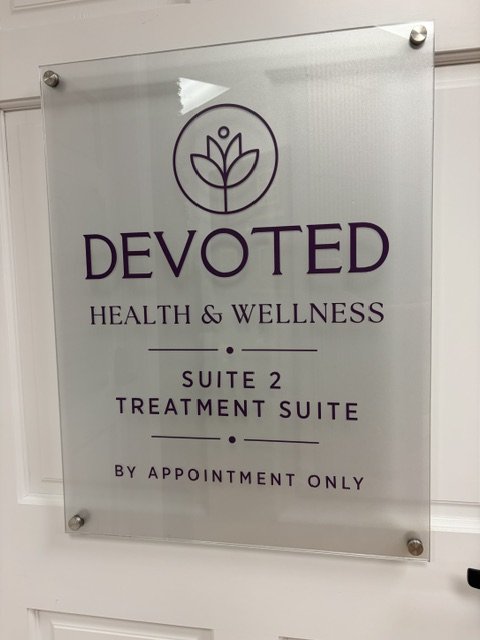 Sign for Devoted Health & Wellness, Suite 2 Treatment Suite, by appointment only.