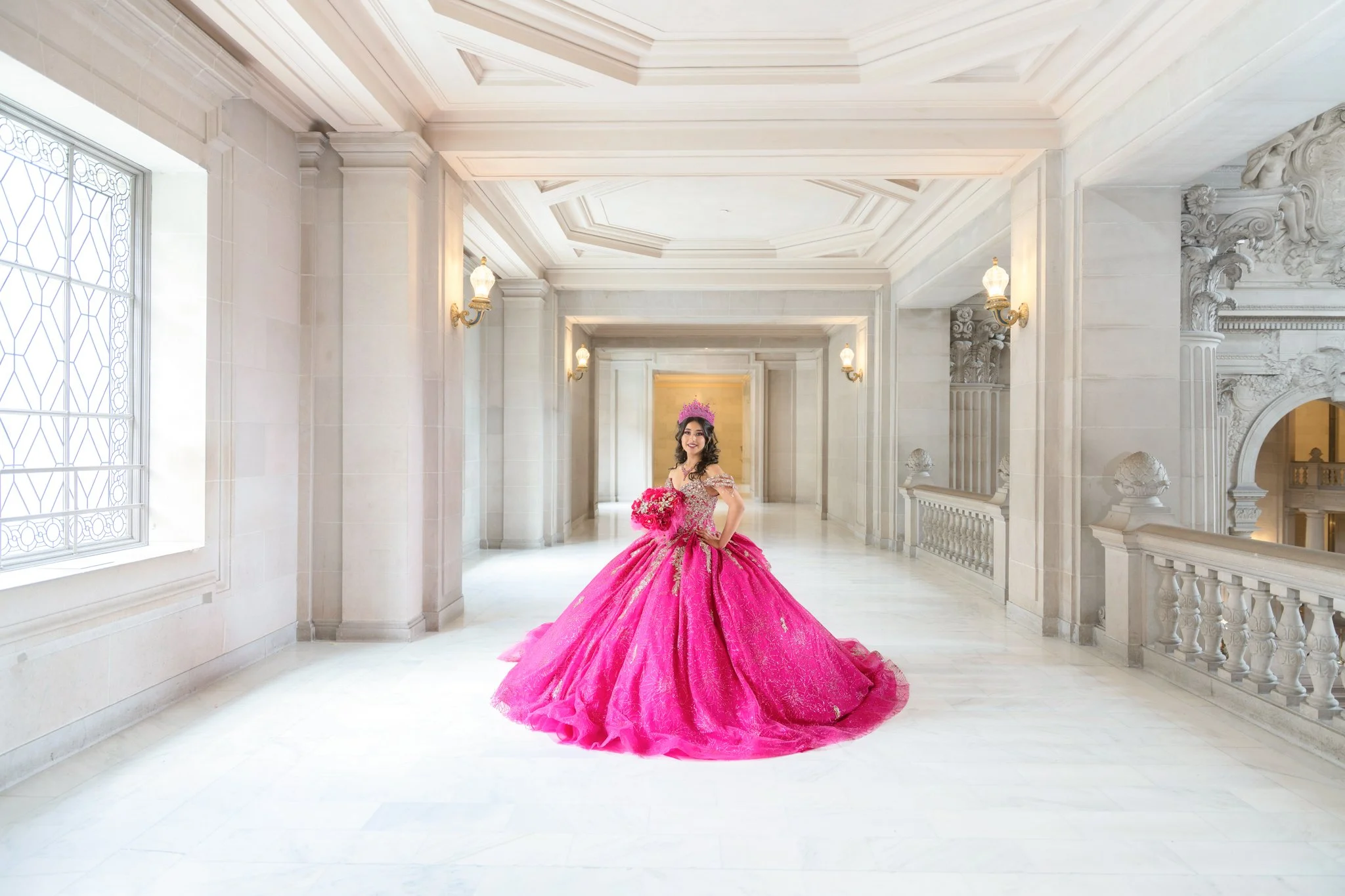 Quinceañera wearing a pink gown in the third-floor gallery at San Francisco City Hall