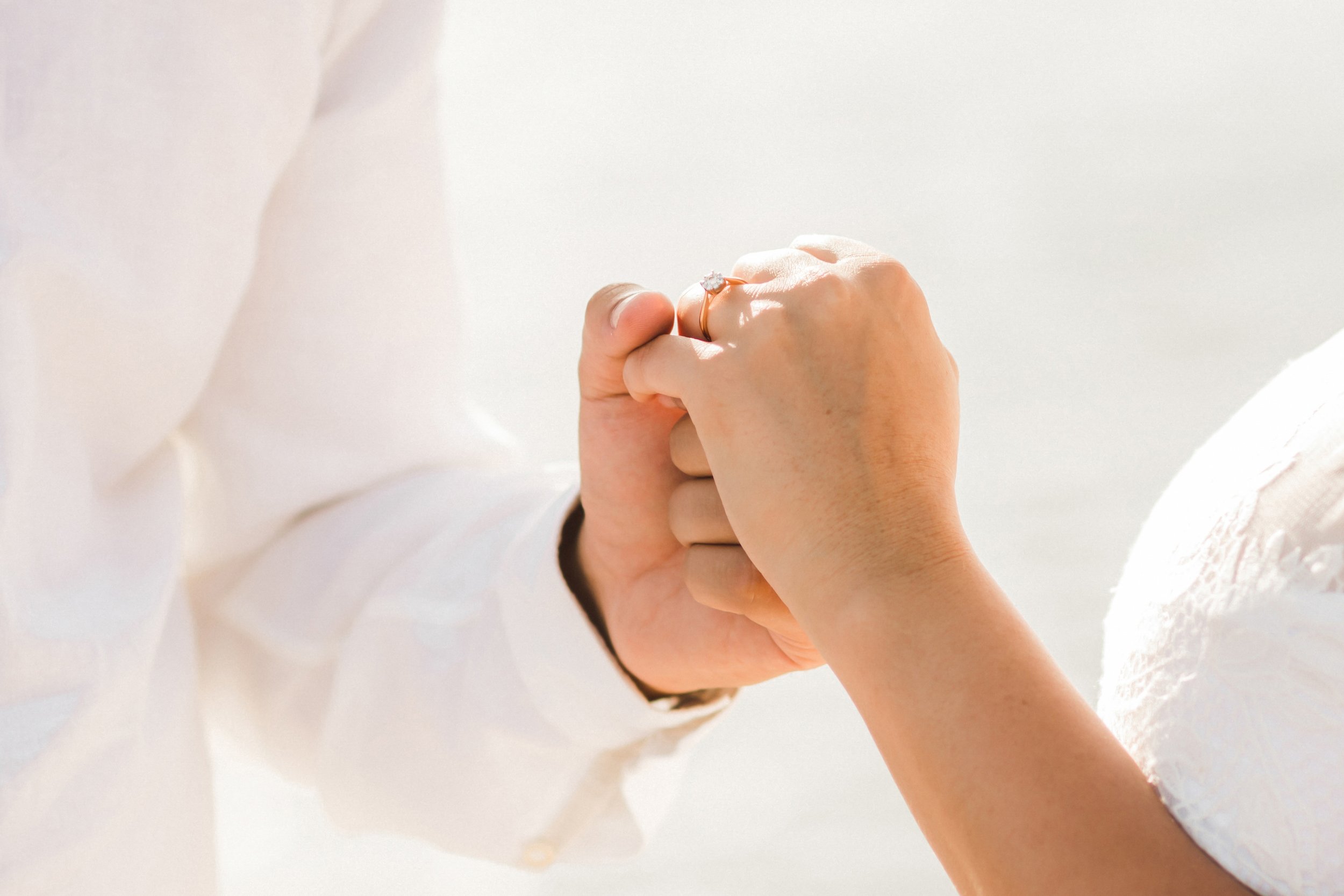 Close-up of newlyweds holding hands and showing their wedding rings after their San Francisco City Hall ceremony.