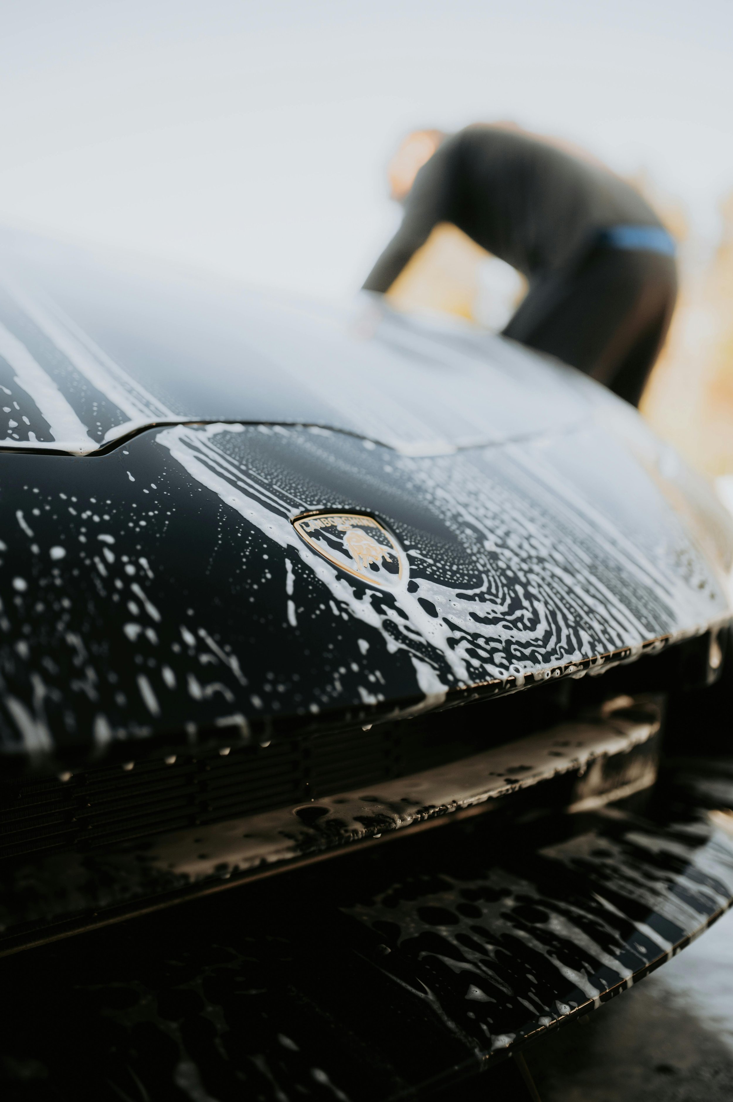 Luxury mobile car detailing in Memphis – black Lamborghini with soap suds during wash by Restoration Rockstar Mobile Detail