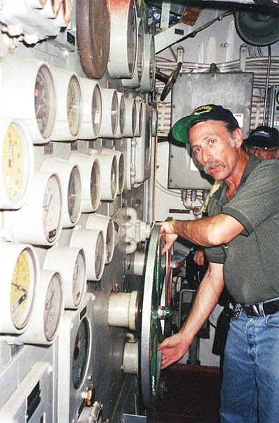 Engine room. Tom Dandes, Volunteer Coordinator, at the wheel.