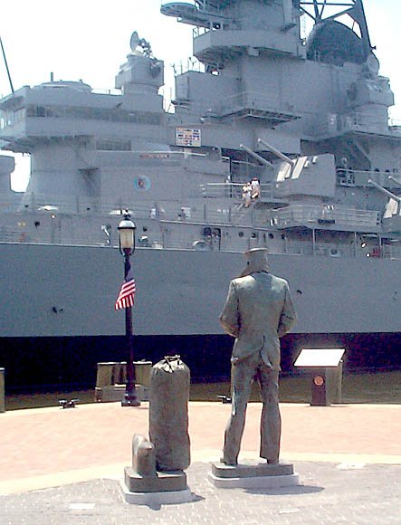 The Lone Sailor keeps watch over the Wisconsin