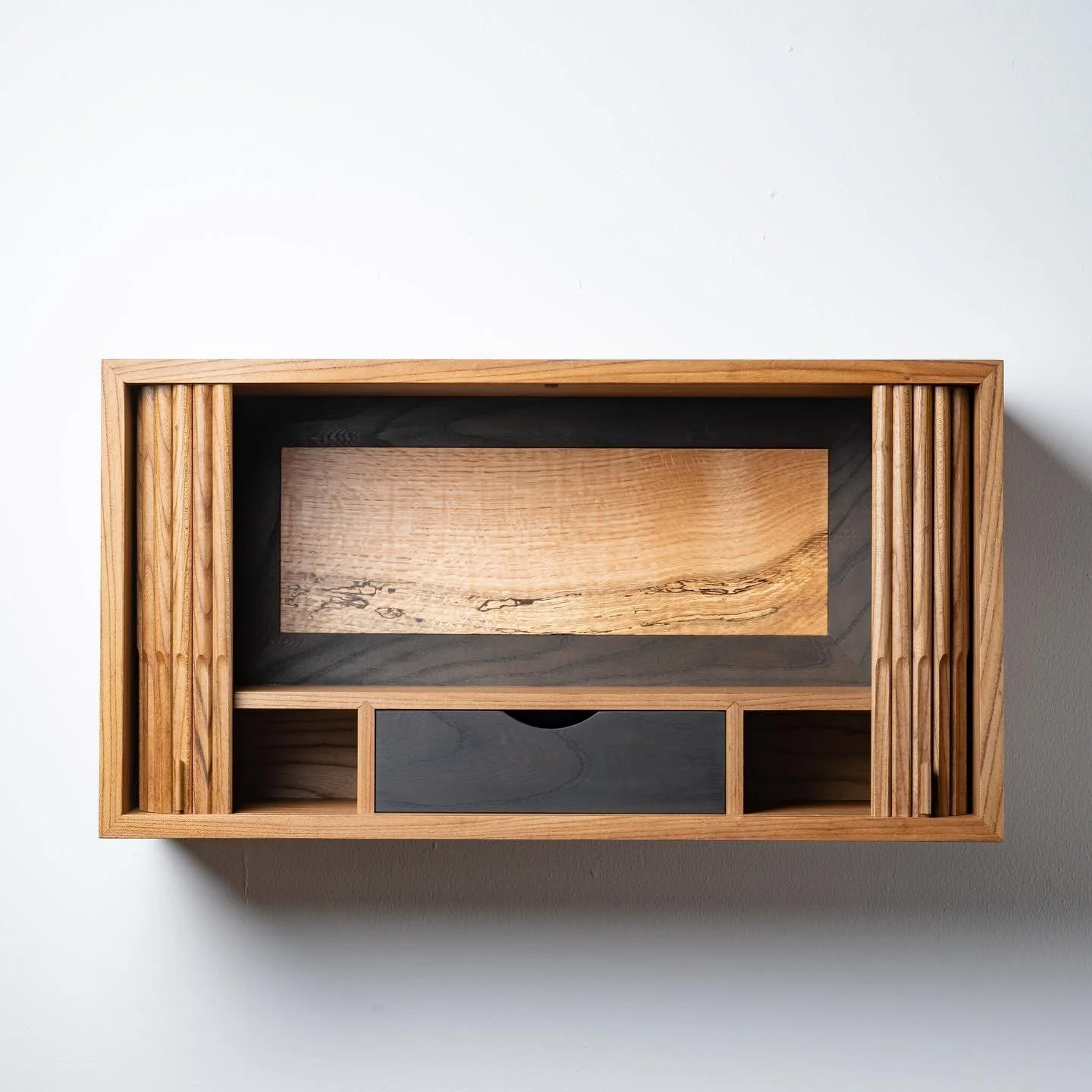 &ldquo;Mirage&rdquo; cabinet in NZ grown Elm and Red Oak. From implementing tambour doors as a starting point, I wanted to be able to reveal something special within. Inside you find a hazy landscape in a piece of spalted red oak. The frame around it