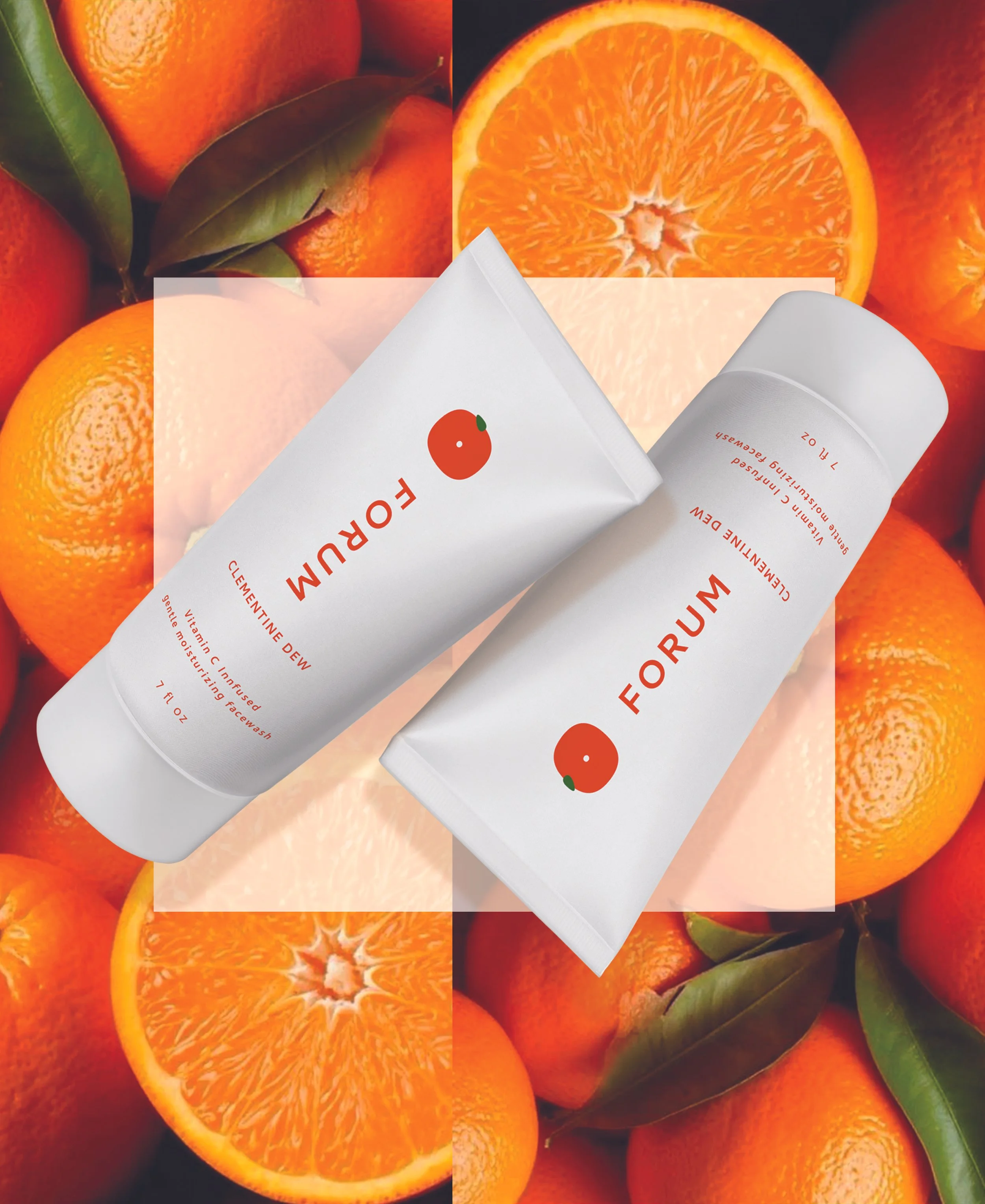 Two white tubes of face wash labeled 'FORUM' with an orange graphic, lying on a background of whole and sliced oranges with green leaves.