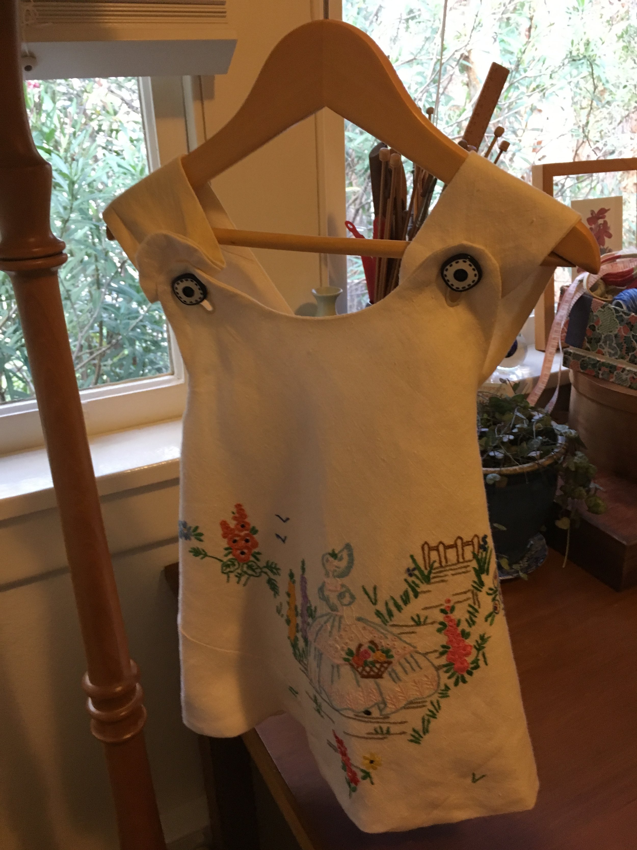 Vintage embroidered tablecloth made into a child's pinafore