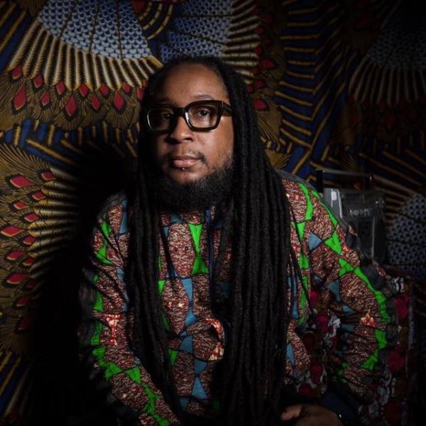 Picture of DJ producer Salah Ananse in African print clothing and African fabric photography studio background