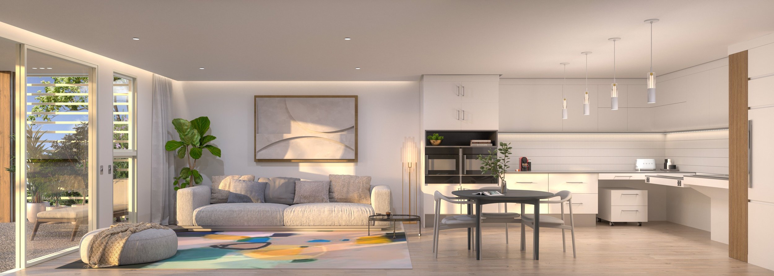 A modern, open-concept living room and kitchen. The room features a gray sofa with cushions, a large abstract painting on the wall, a potted plant, and a colorful rug. The kitchen area includes sleek white cabinets, a round dining table with chairs, and pendant lighting. Large windows with a view of greenery and a sliding door lead to an outdoor space.