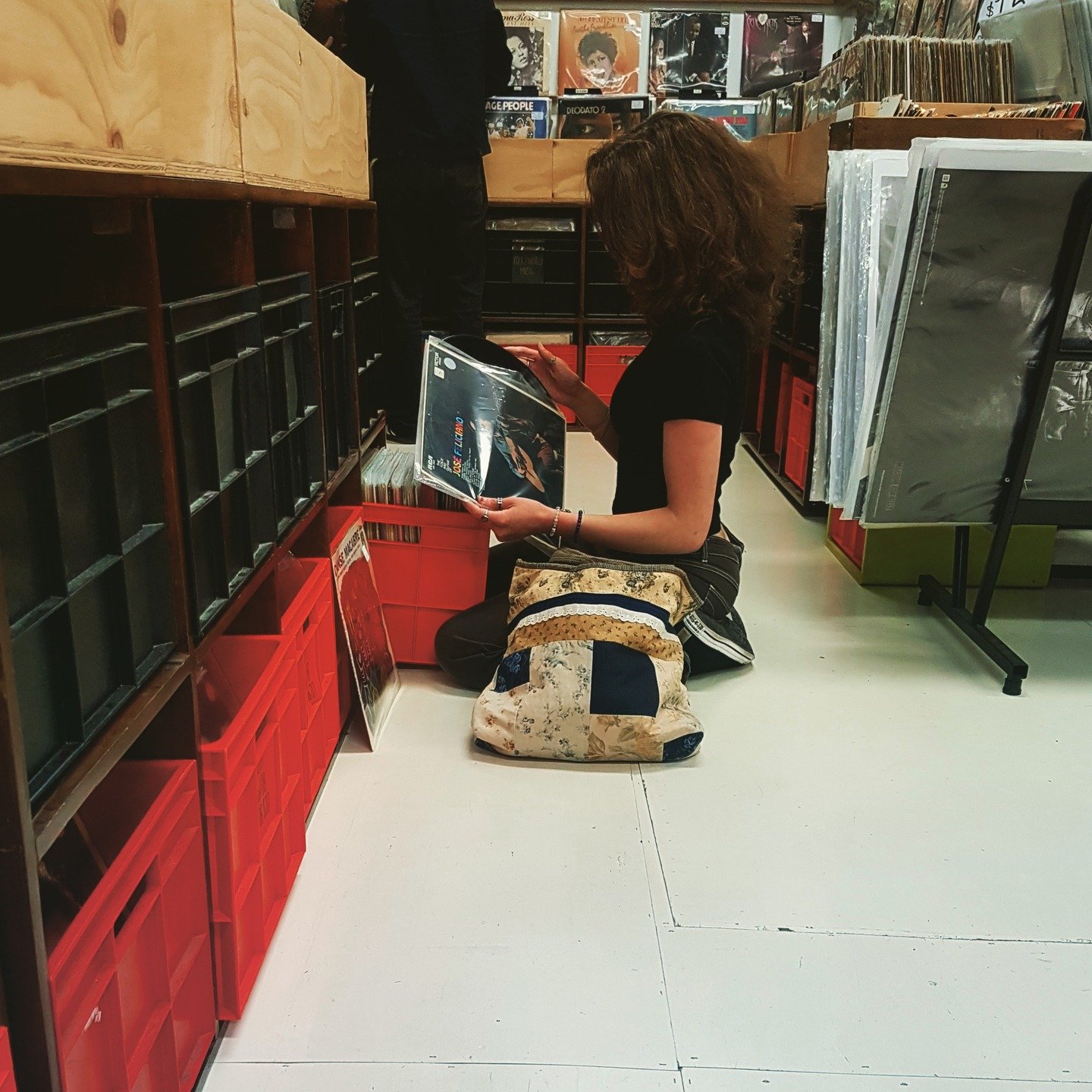 There was just something about this moment that has me in awe. I was stunned at the simplistic, raw beauty of this women, kneeling on the floor, almost child like, zero f*$@'s given, diving into the pile of old-school vinyl. As I stood in silent appr