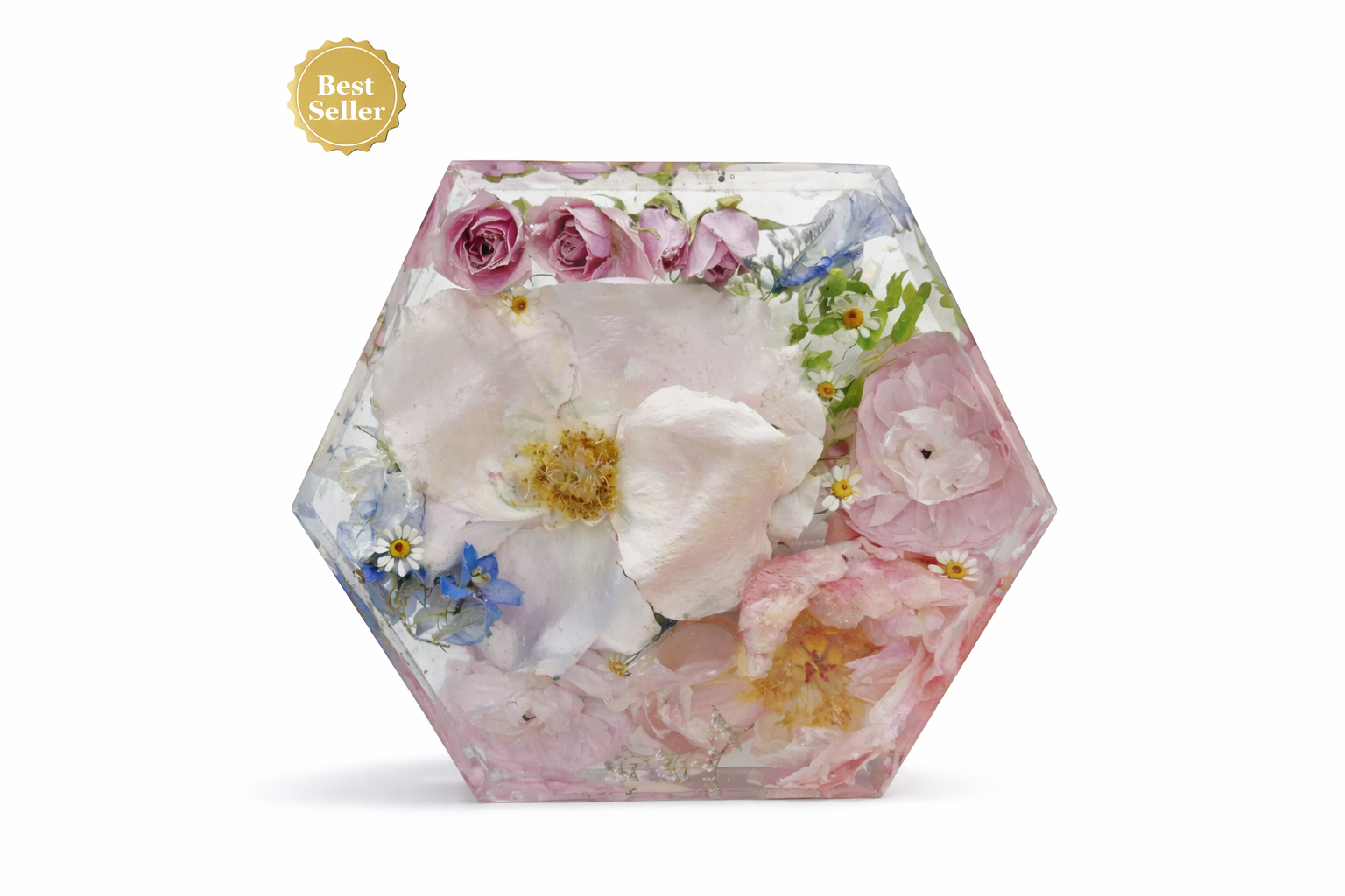 Hexagonal transparent container filled with pink, white, and purple flowers, including roses and daisies, with a gold 'Best Seller' badge in the top left corner.