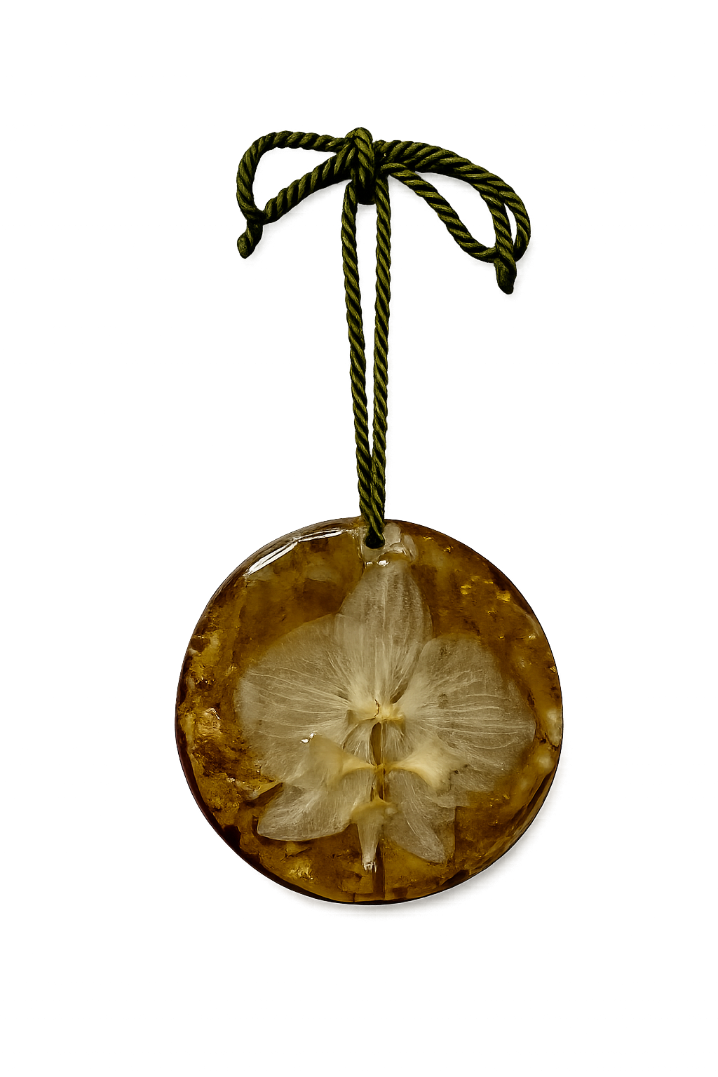 A round pendant with a slice of an orange fruit, showing the inner sections and white pith, hanging from a green twisted cord against a colorful background with purple and blue lights.