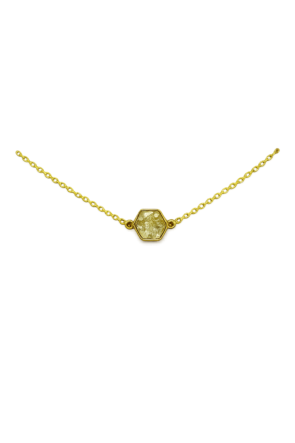 Gold necklace with hexagon-shaped gemstone pendant on a dark background