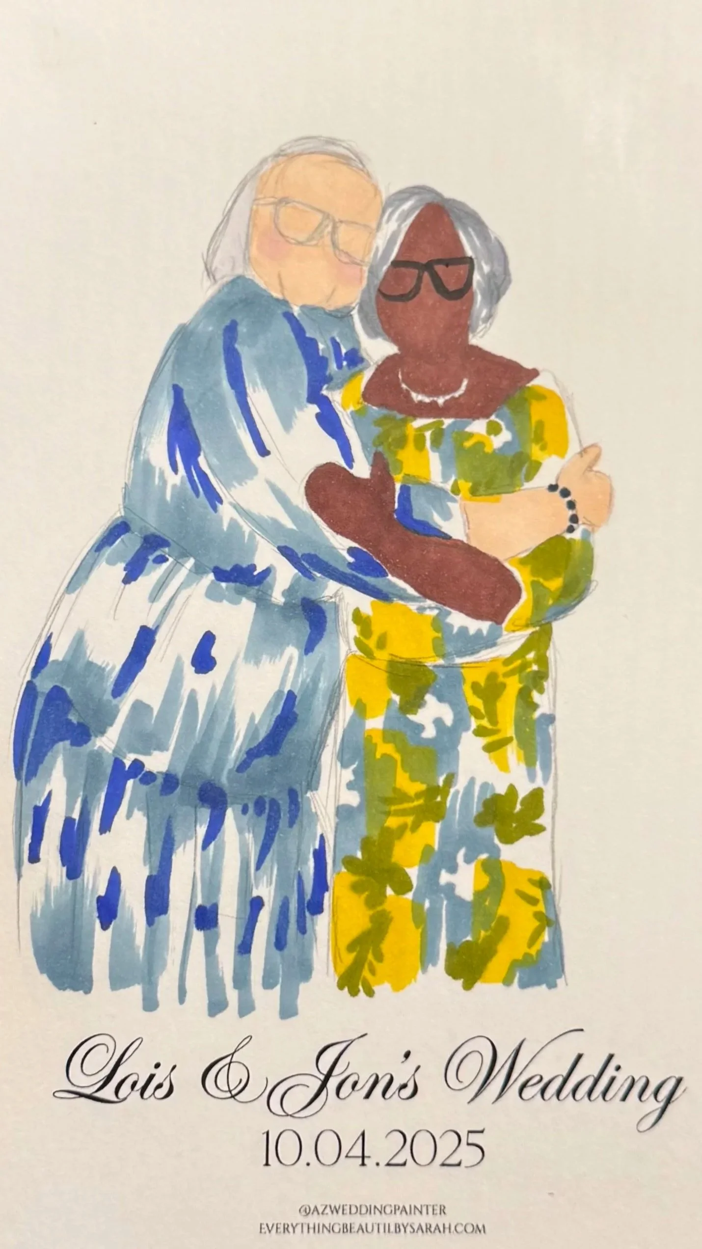 Illustration of two women, one with light skin and gray hair wearing glasses and a blue dress, and the other with dark skin and gray hair wearing glasses and a yellow floral dress, embracing at a wedding. Text reads "Lois & Jon's Wedding" with date 1