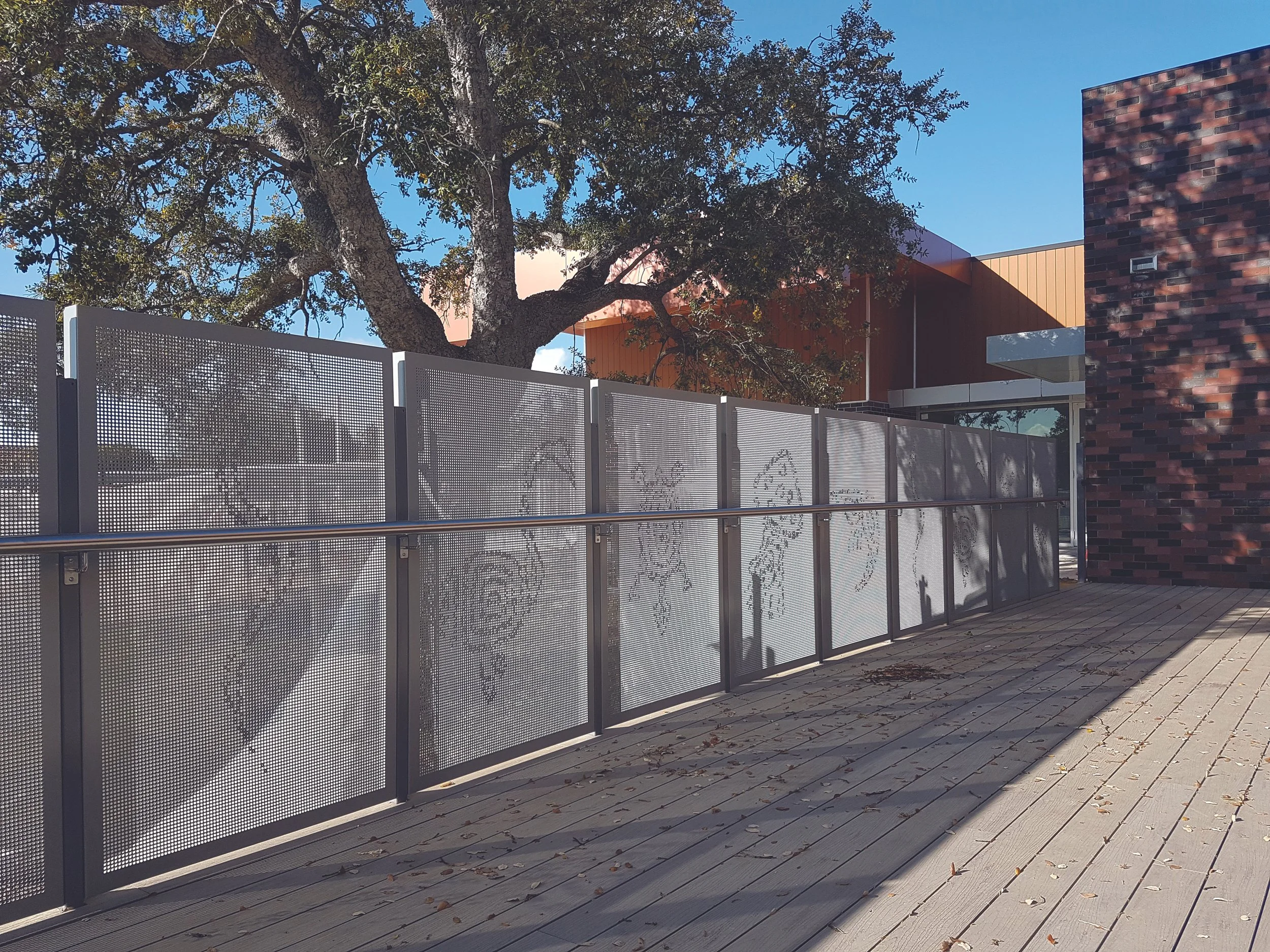 A perforated metal fence with a custom image to perforation on security gates.