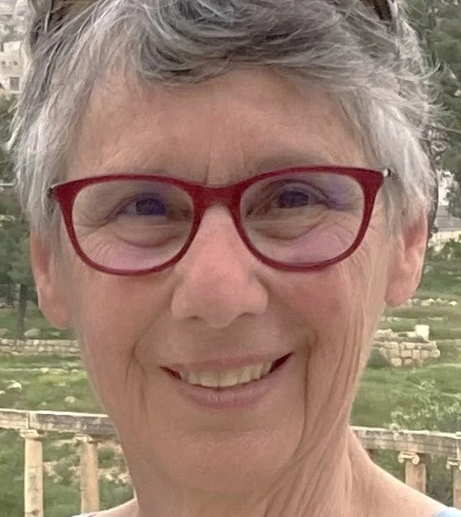 Woman with red glasses and gray hair