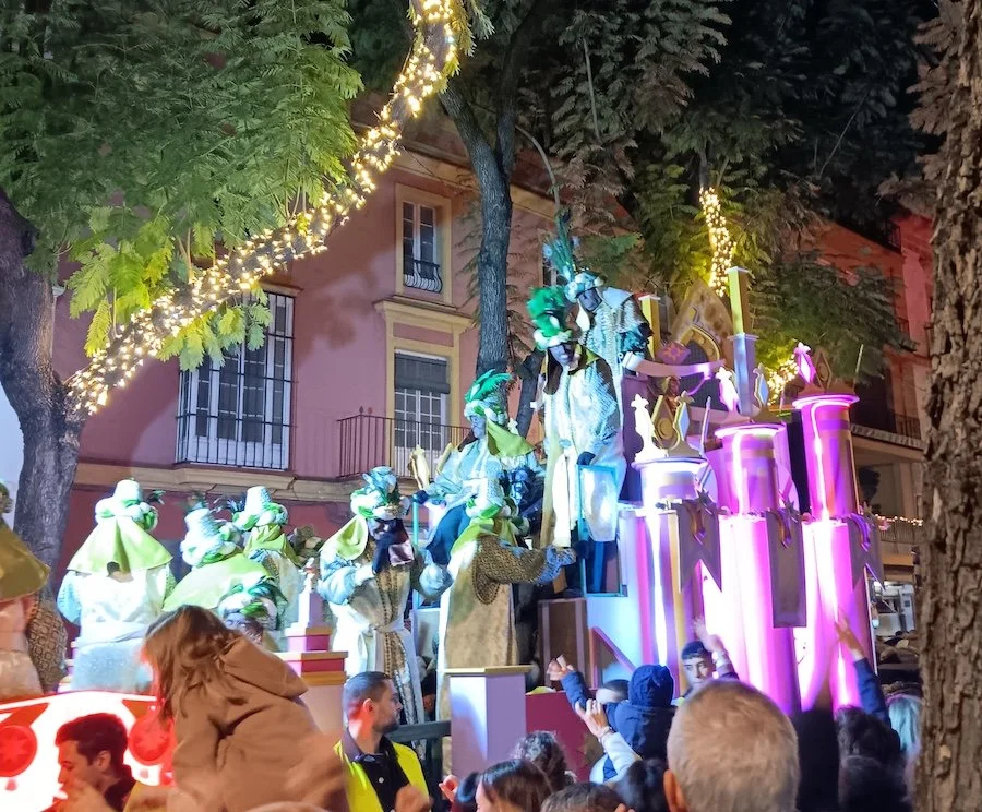 A float carrying people dressed as one of the three Wise Men and his followers
