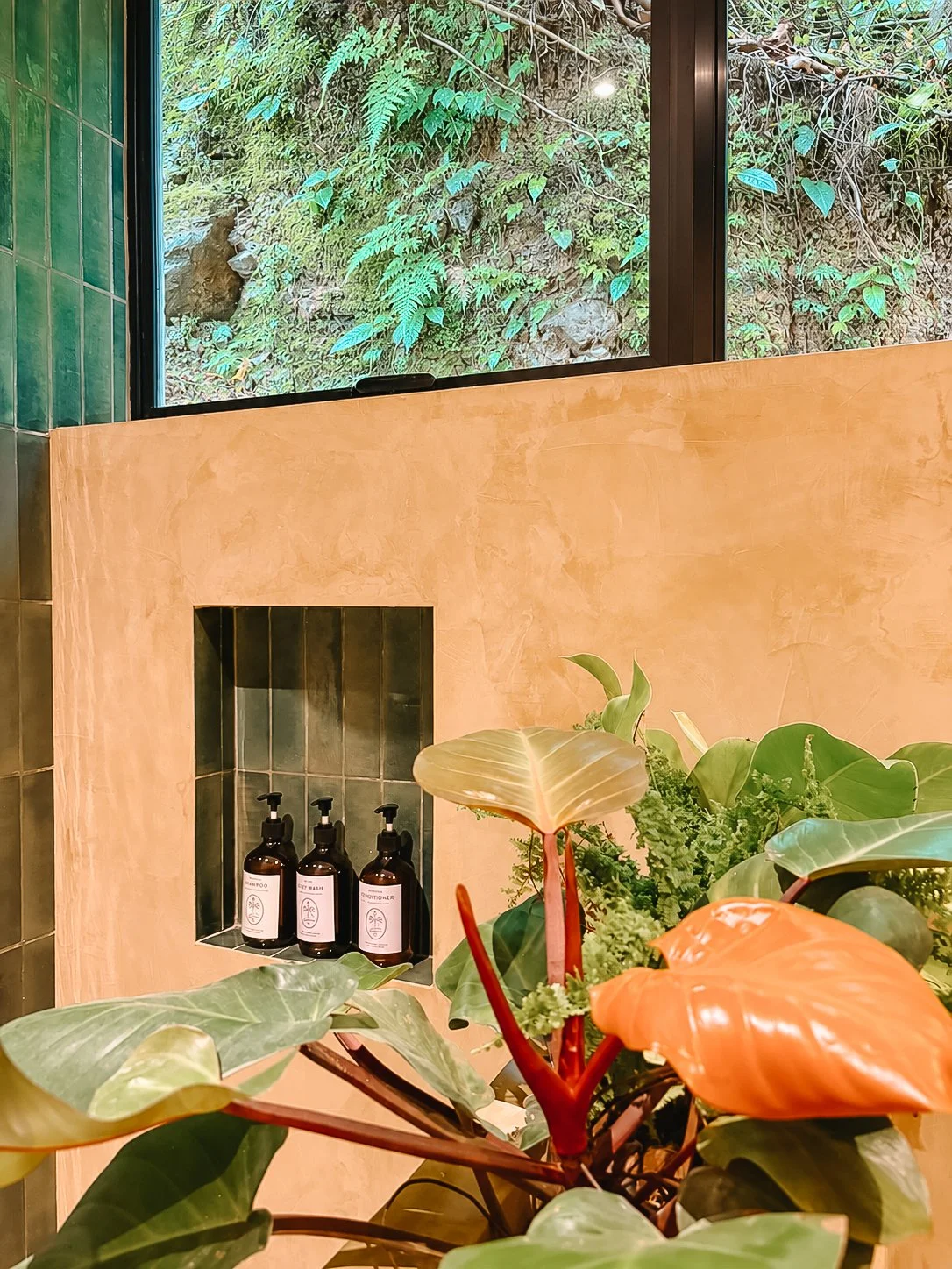 Tiled niche with amenities, framed by jungle views and greenery.