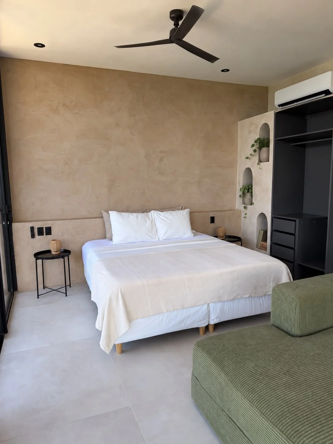 King-size bed beneath a slow-turning ceiling fan, with air conditioning for warmer nights.