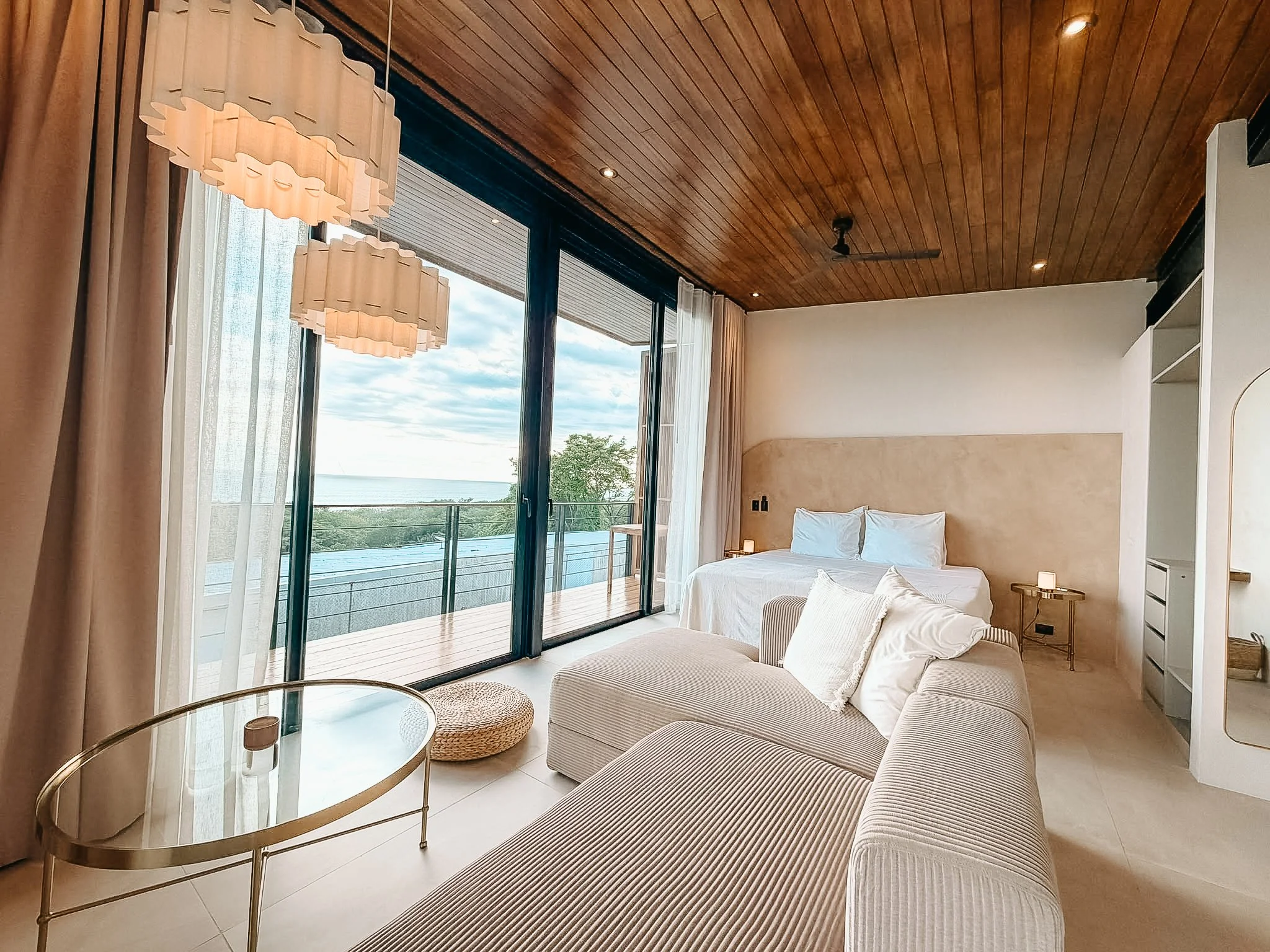 Open-plan Casa Surya studio with a king-size bed, comfortable lounge area and ocean views.