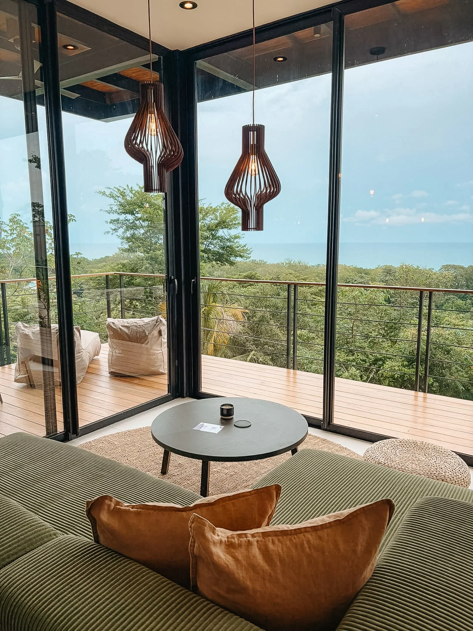 Casa Selva lounge corner with ocean views through floor-to-ceiling windows, Santa Teresa