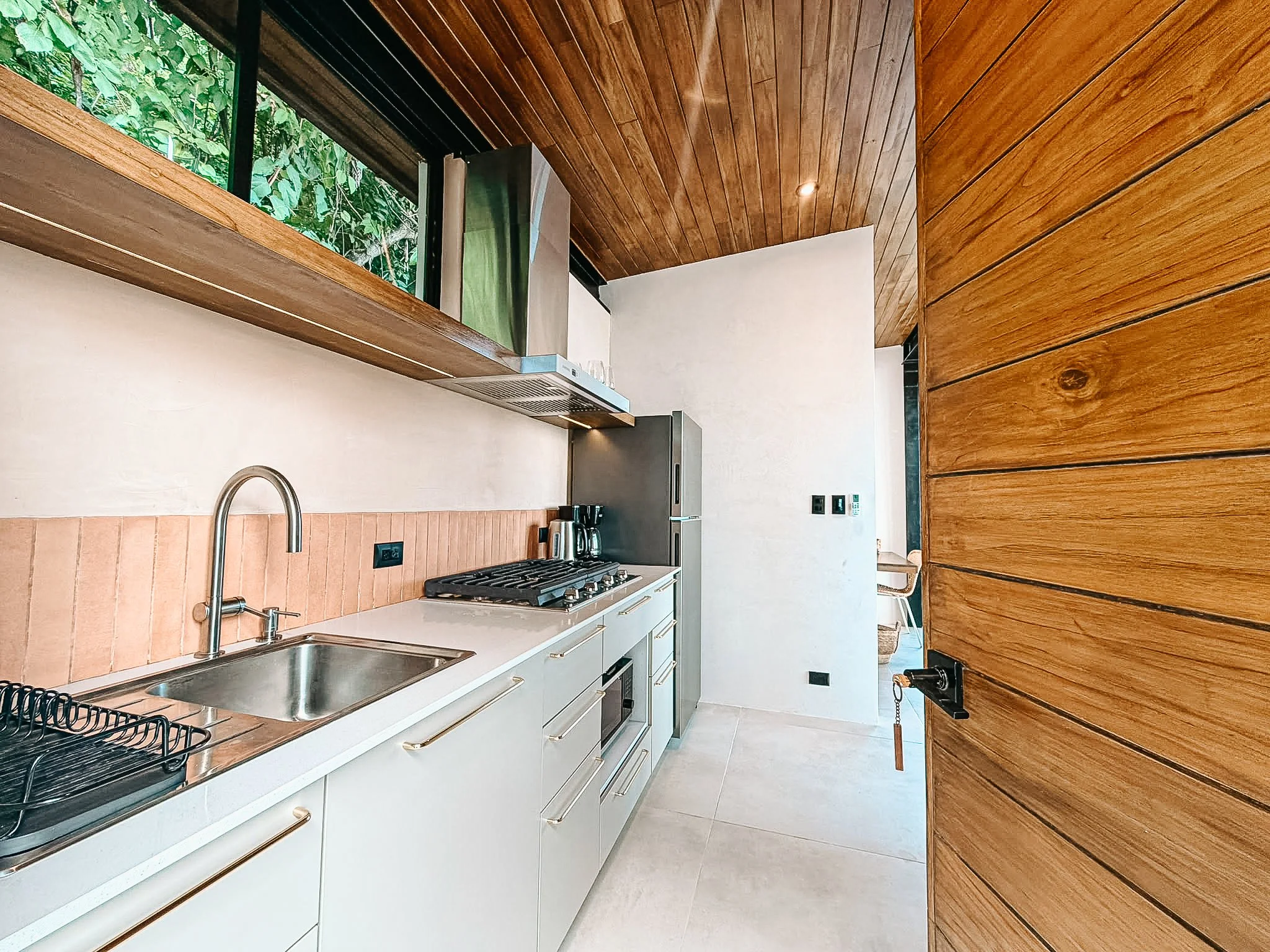 Fully equipped kitchen at Casa Surya with a gas cooktop, refrigerator and generous counter space.