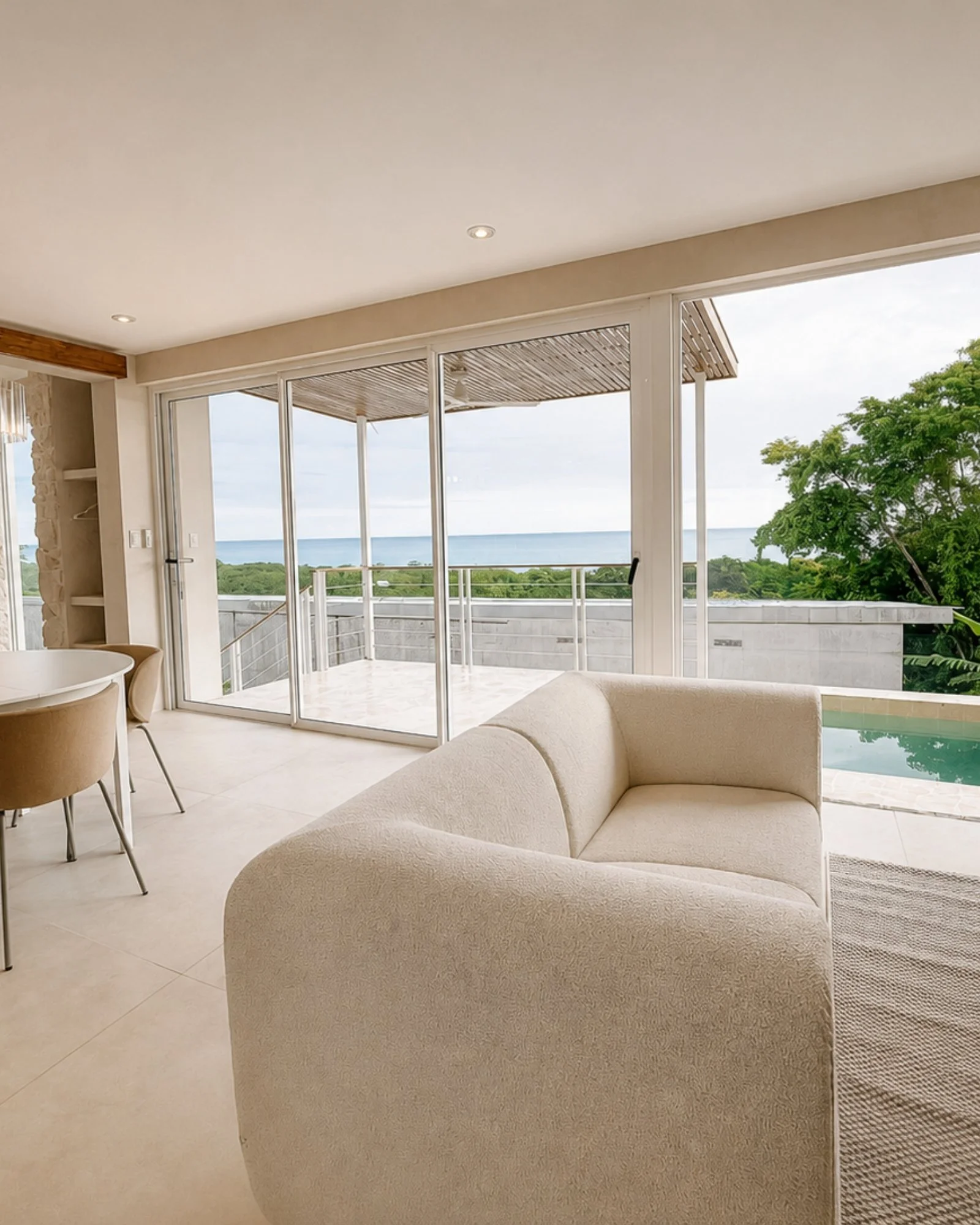 Open-plan living, dining and kitchen area at Casa Cueva with ocean views and a private plunge pool in Santa Teresa, Costa Rica.