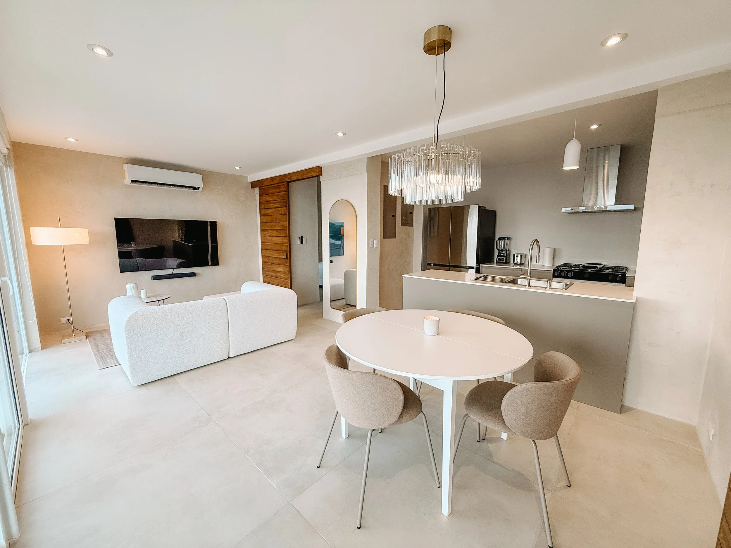 Open-plan living, dining and kitchen area in Casa Cueva at VISTA NALU in Santa Teresa, Costa Rica.
