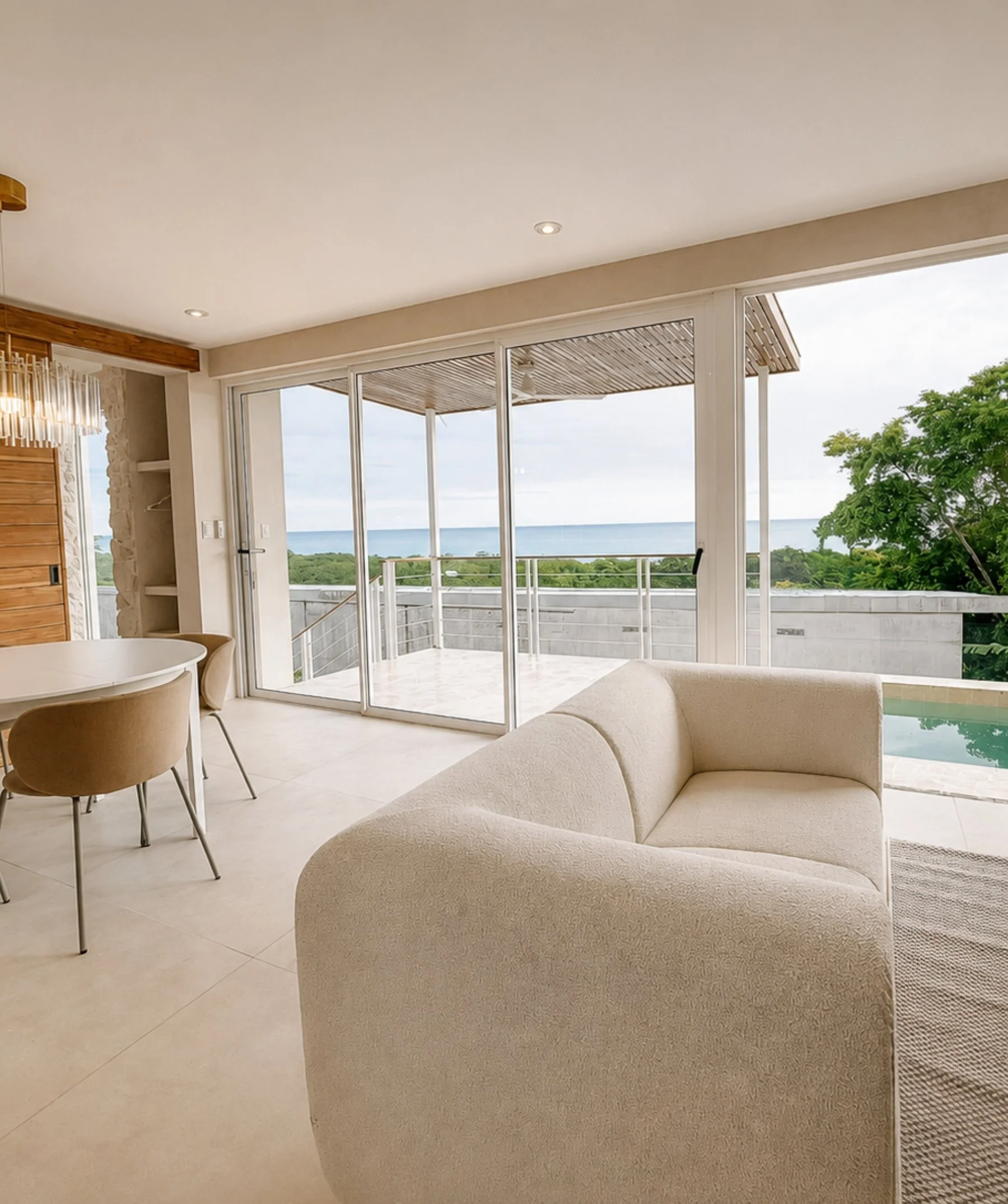 Open-plan living, dining and kitchen area at Casa Cueva with ocean views and a private plunge pool in Santa Teresa, Costa Rica.