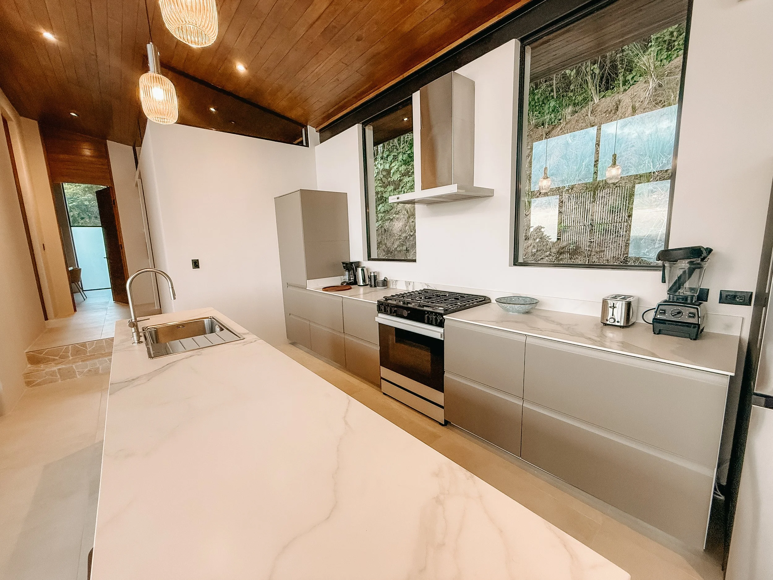 Fully equipped kitchen at Villa Nalu with a large island, gas range and modern appliances.