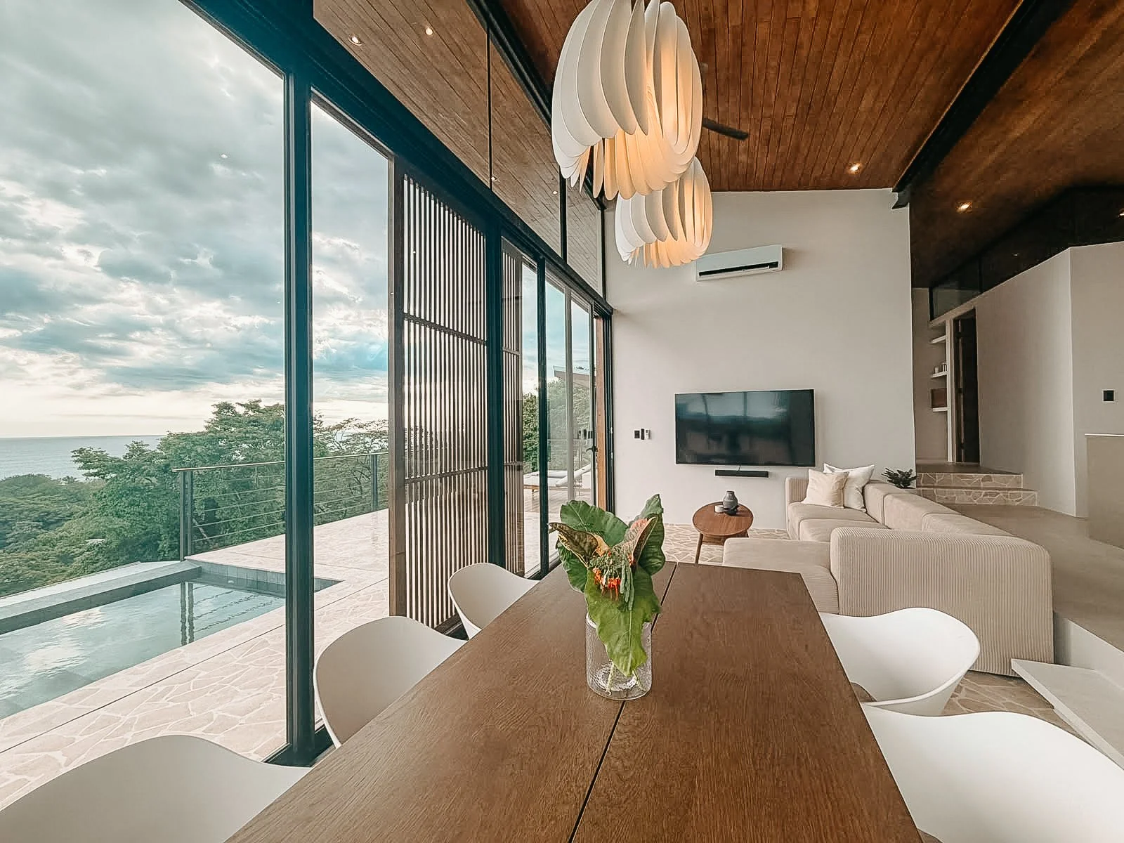 Villa Nalu dining and living area opening onto the private pool and panoramic Pacific Ocean views.