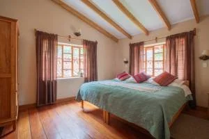 Two people examining colorful, intricately patterned textile art and beadwork.