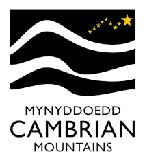 Cambridge Mountains logo with stylized black and white wavy lines and a yellow starry sky