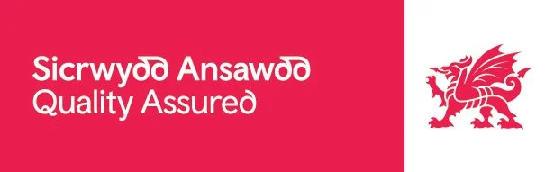 A red and white banner with the text "Sicrwydd Ansawdd Quality Assured" and a red dragon logo.