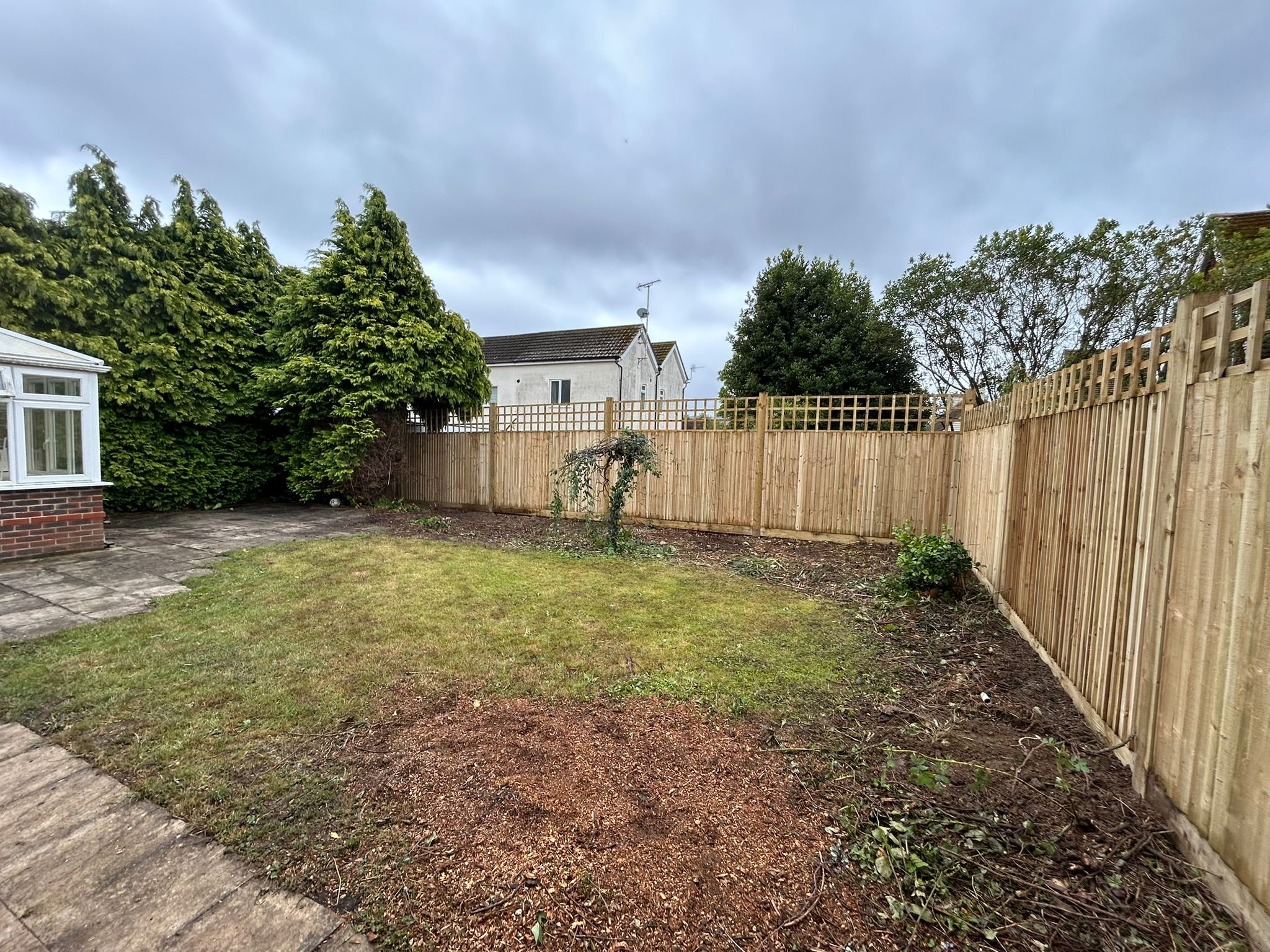 Closeboard Fencing with Wooden Posts and Wooden Gravel boards and Trellis.