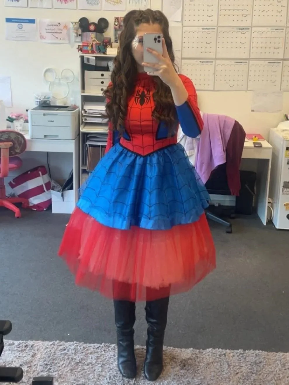woman dressed as spidergirl taking a mirror selfie
