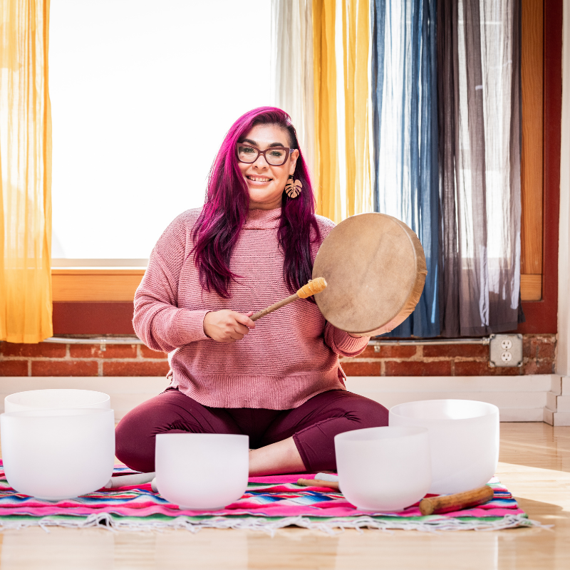 Klaudia Paletta, founder of Pink Means Go, seated with Tibetan singing bowls