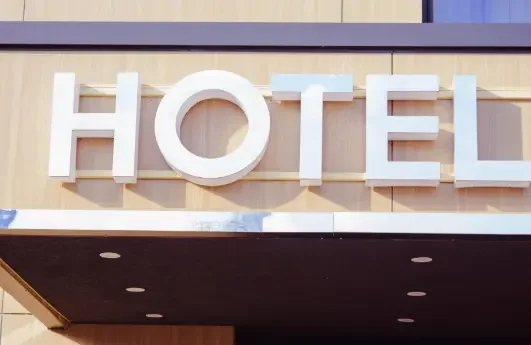 Close-up of a hotel sign with large white letters spelling 'HOTEL' on the building exterior.