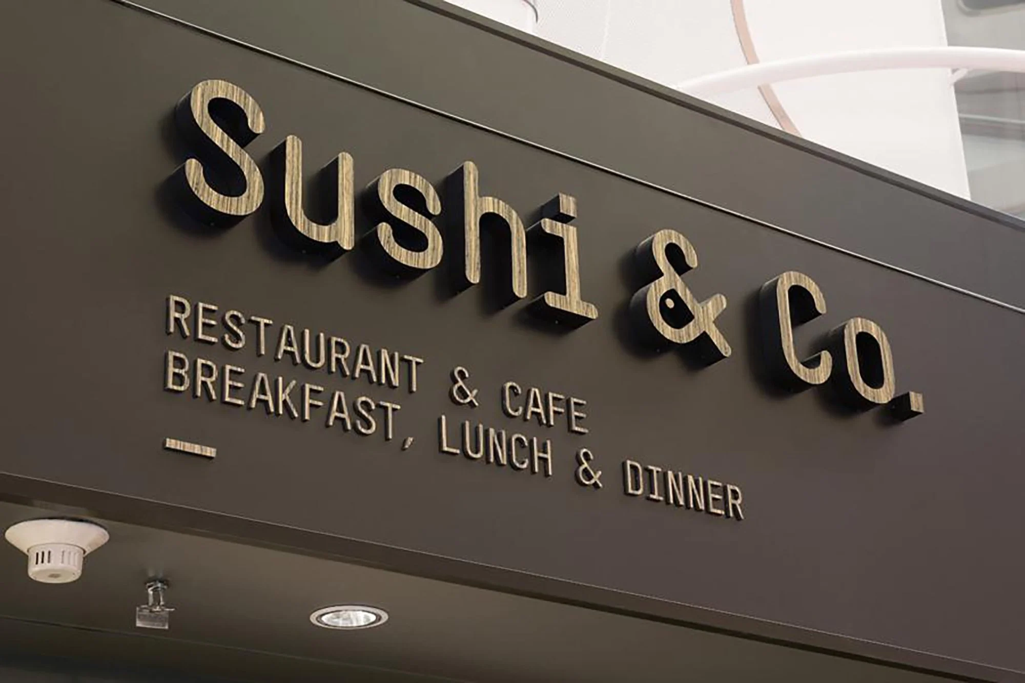 Sign for Sushii & Co. restaurant and café, offering breakfast, lunch, and dinner.