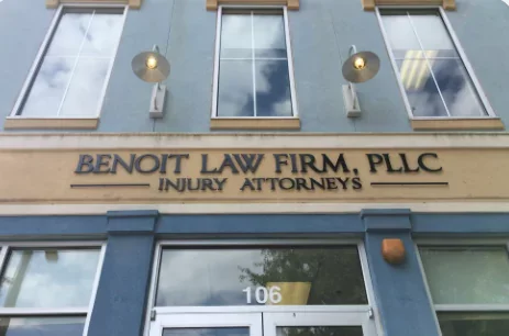 Exterior of a building with a sign that reads "Benioff Law Firm, PLLC Injury Attorneys" and the number 106 above the entrance.