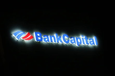 Illuminated channel letters installed above the entrance of a modern bank branch